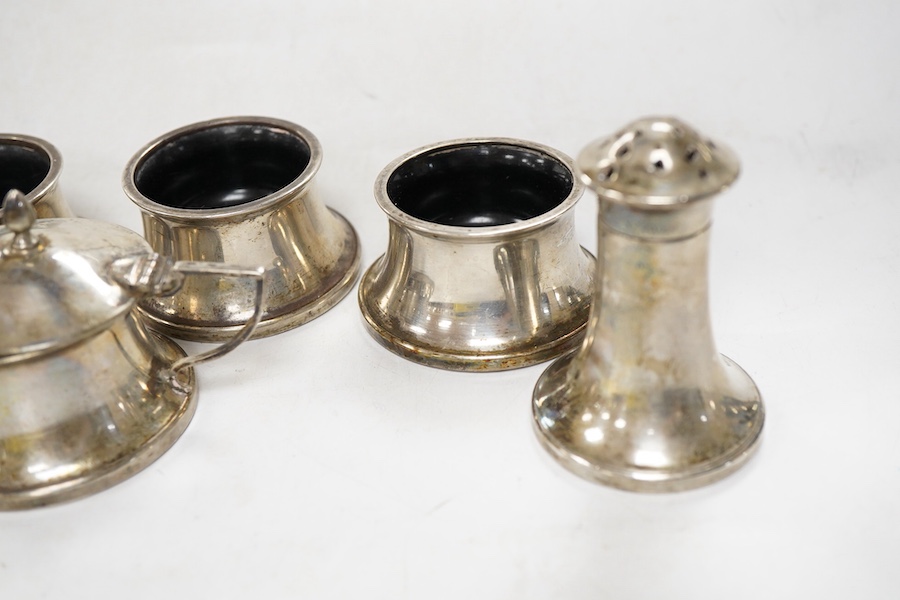 A George V seven piece silver mounted condiment set, by Joseph Gloster Ltd, Birmingham, 1932, pepper 65mm (a.f.).